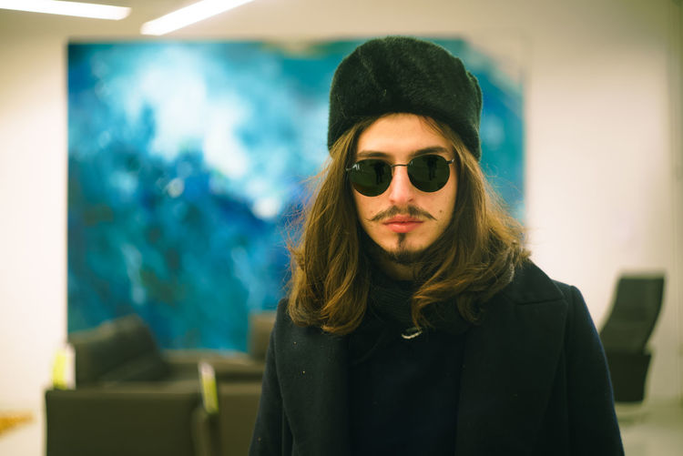 Young man with long hair wearing sunglasses
