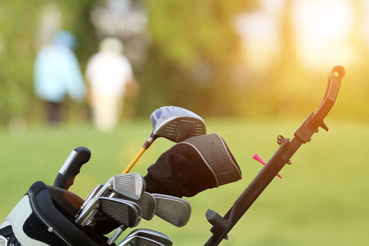 Close-up of golf club on grassy field