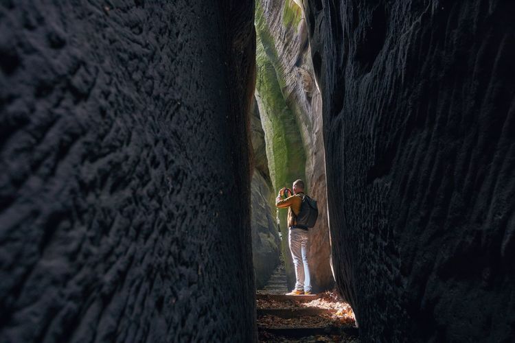 Full length of man standing amidst wall