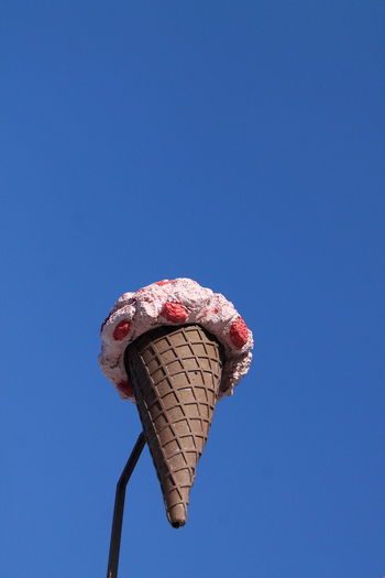 Close-up of ice cream against blue sky