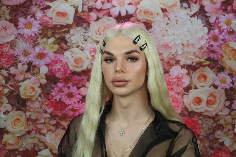 Portrait of transgender against flowering background