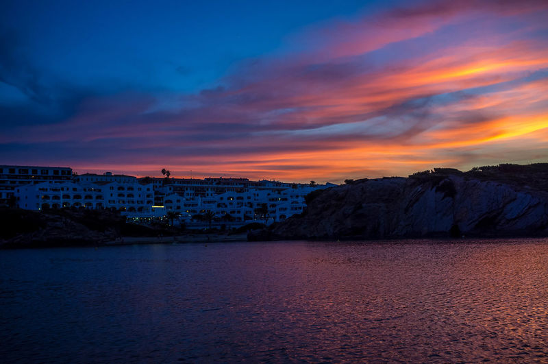Scenic view of sea against romantic sky at sunset