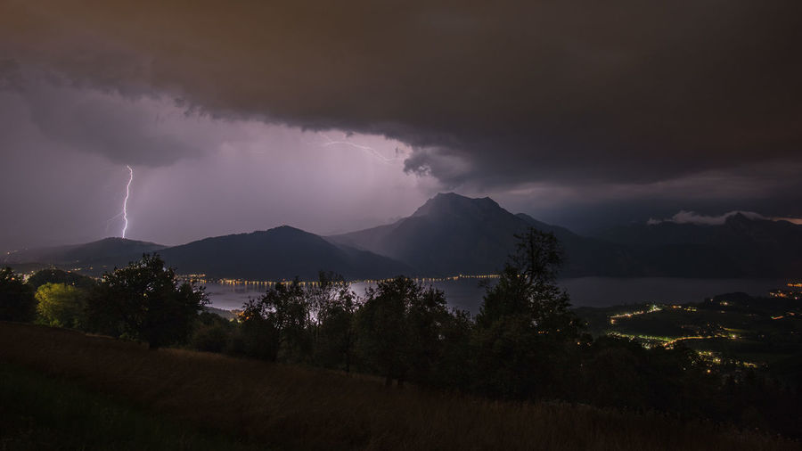 Panoramic view of lightning over mountain against sky at night