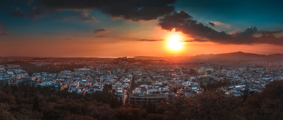 Panoramic view of cityscape against sky during sunset
