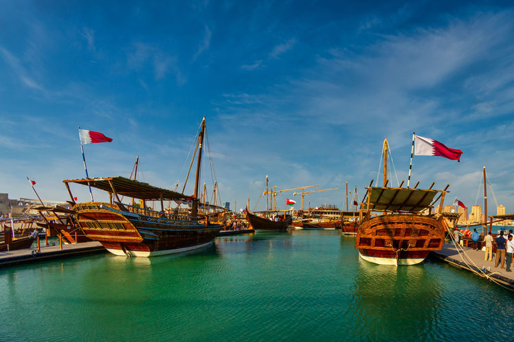 Dhows in katara beach qatar daylight view with qatar flag and clouds in sky