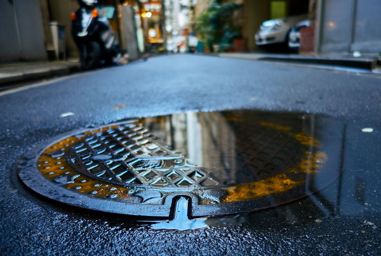 Close-up of wet manhole on street