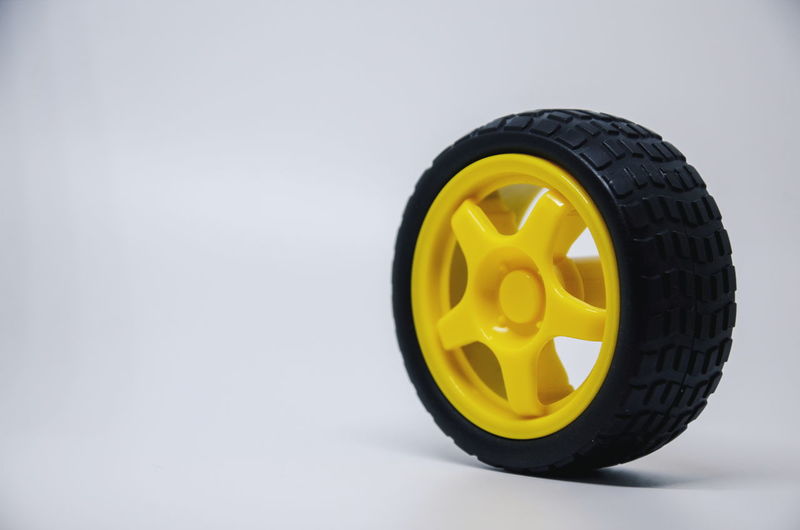 Close-up of yellow toy car over white background