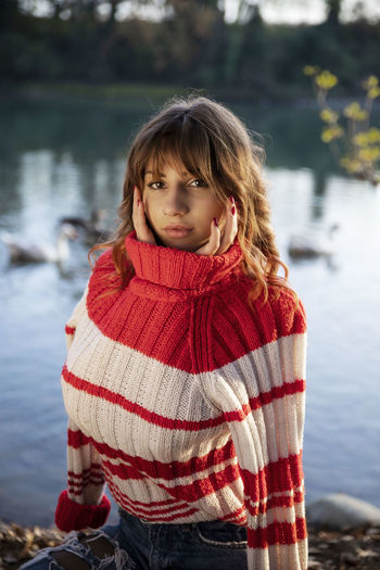 Portrait of girl standing by lake