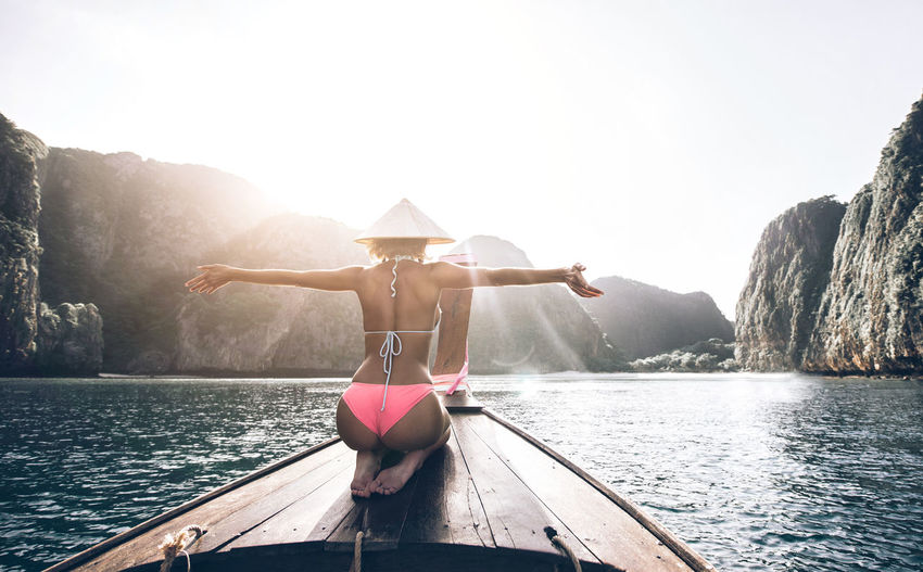 Woman on longtail boat in sea