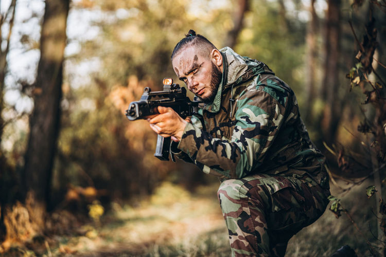 Man holding camera in forest