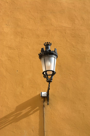 Low angle view of lamp post on wall