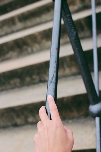 Cropped hand holding railing