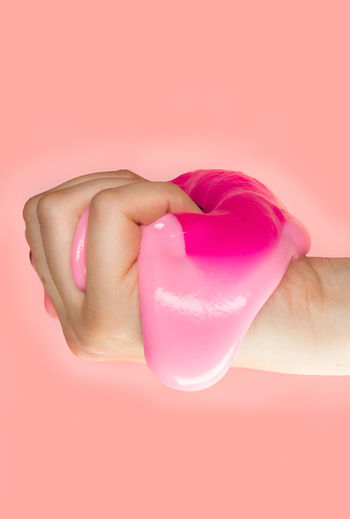 Close-up of hand holding pink petals