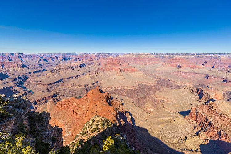 Scenic view of landscape against clear blue sky