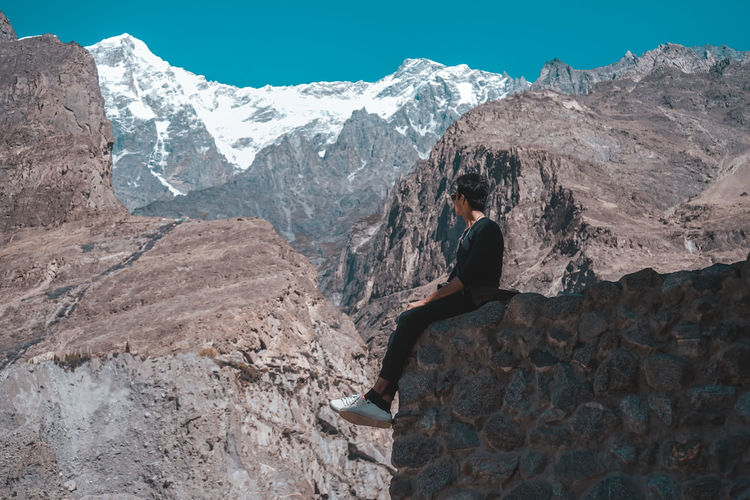 Man while sitting on mountain