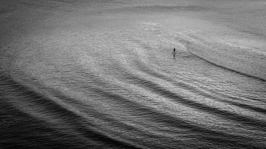 Man paddle boarding in sea