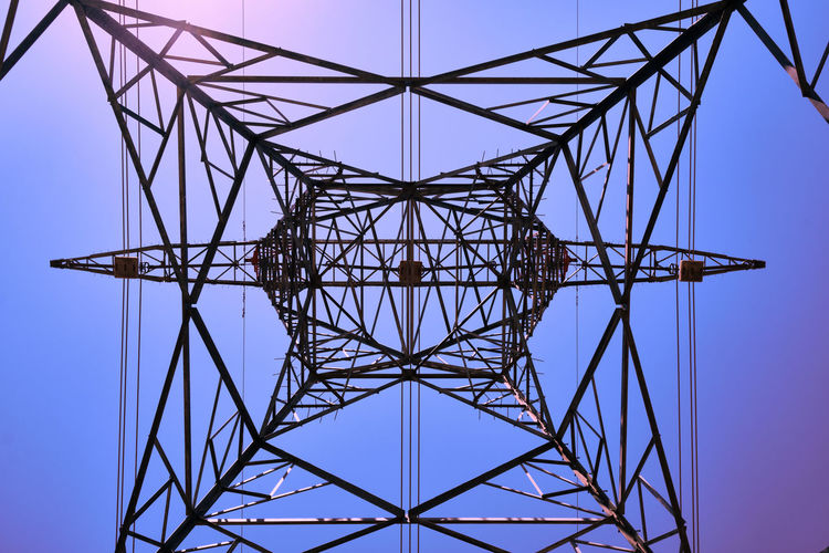 Directly below shot of of electricity pylon against clear sky
