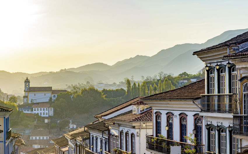 Facades of ancient colonial style houses in ouro preto city at sunset