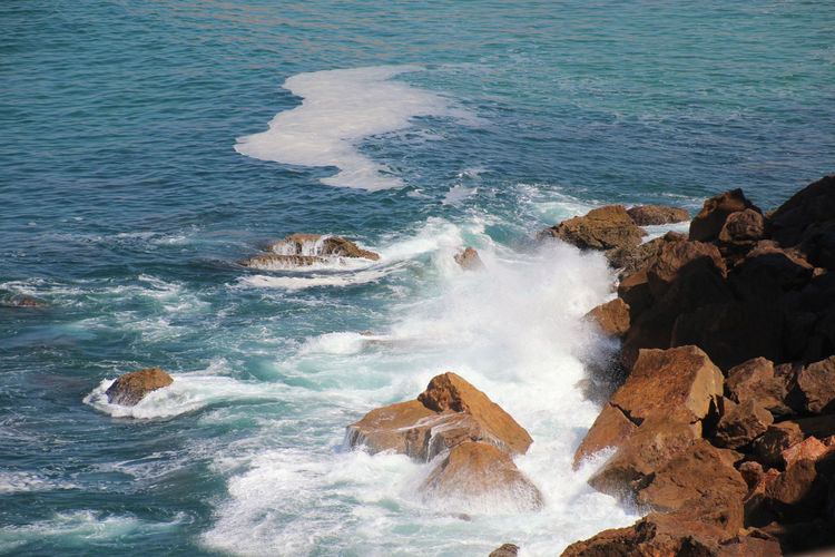 High angle view of rocks in sea