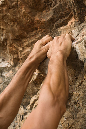 Midsection of human feet on rock