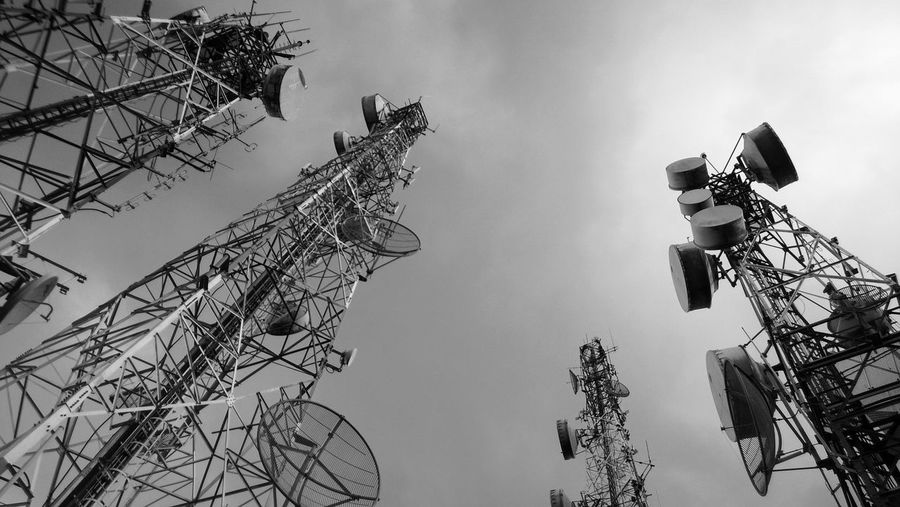 Telecommunication towers with sky in black and white