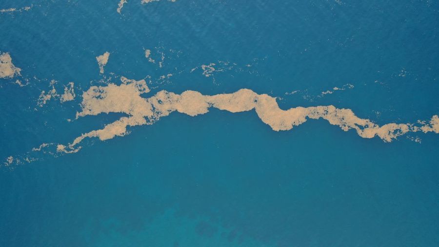 High angle view of blue sea against sky