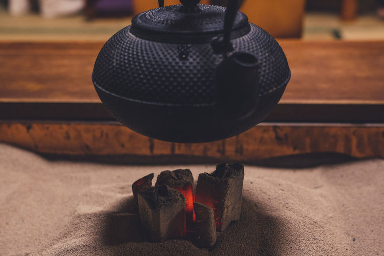 Kettle hanging over burning fire pit