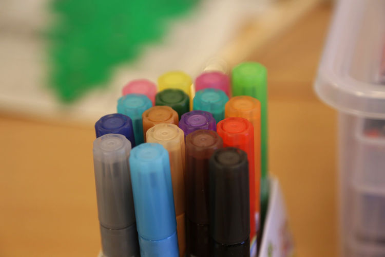 Close-up of multi colored pens on table