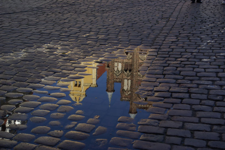 Reflection of church on puddle