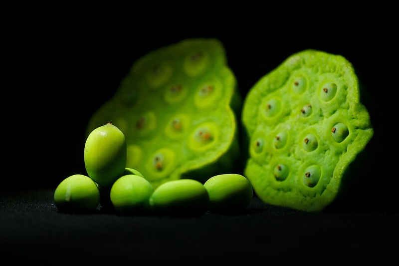Close-up of green eggs against black background