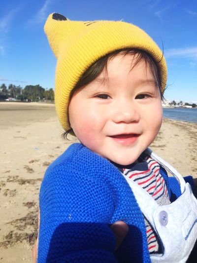 Portrait of boy wearing knit hat at beach