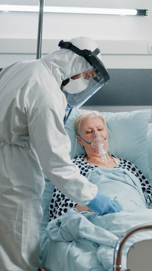 Portrait of female doctor examining patient in hospital