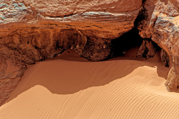 Rock and fine sand with ripple marks and wind ripples in the desert of wadi rum, jordan, middle east