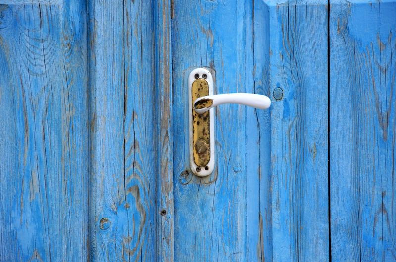Background of blue wooden door with close-up handle