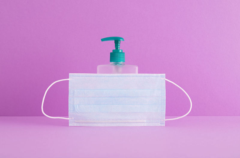 Close-up of bottle against pink background