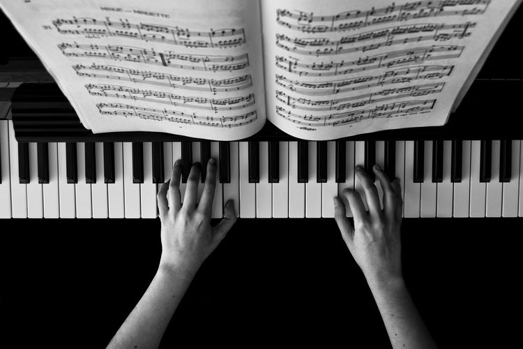 Directly above view of person playing piano
