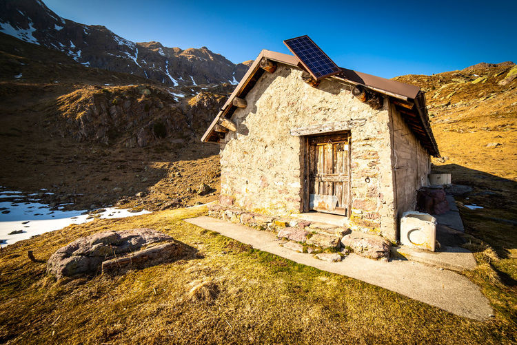 Mountain hut with solar panel alternative energies and time to disconnect concept