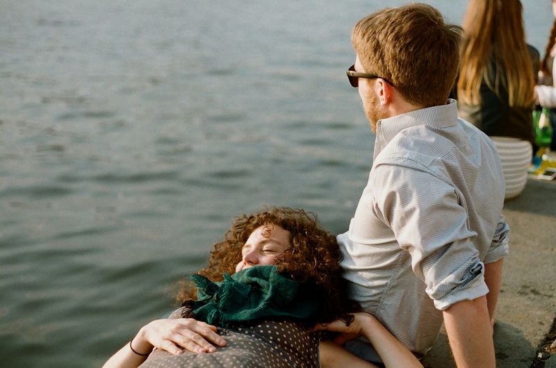 Full length of happy friends against sea