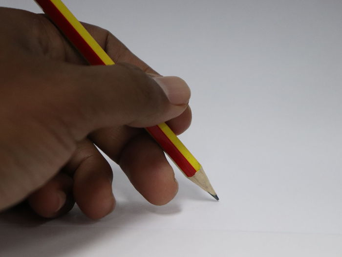 Close-up of human hand holding paper