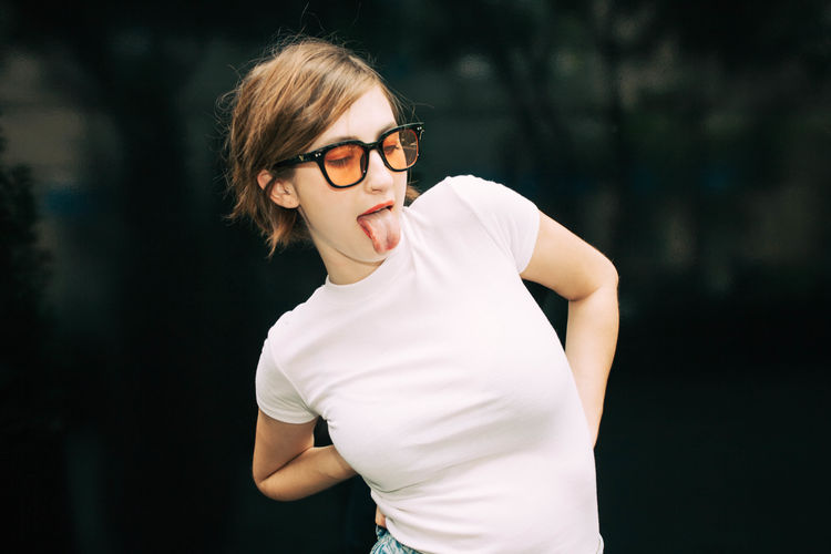 Silly Tongue Out Youth Day Eyeglasses Hip Hipster Leisure Activity Lifestyles Looking At Camera One Person Outdoors People Portrait Real People Young Adult Young Women Youth Culture
