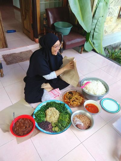 High angle view of woman having food at home