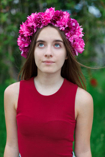 Portrait of beautiful woman with pink flower