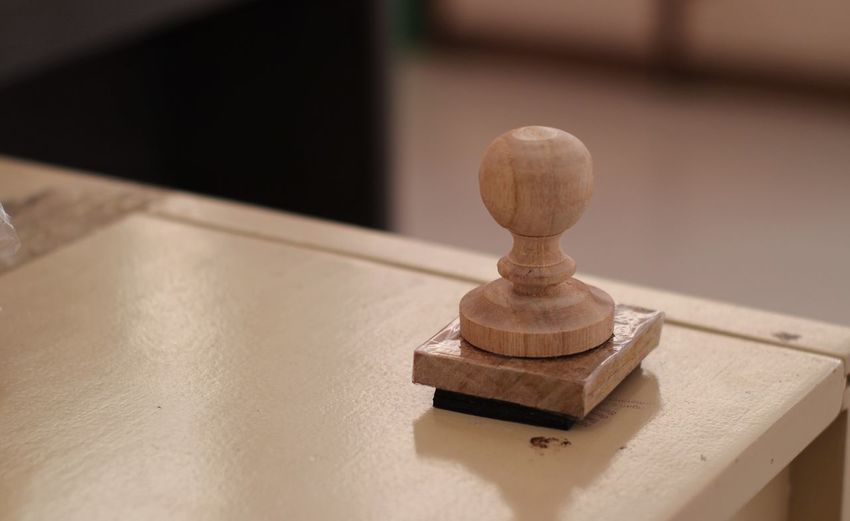 Close-up of stamp on table