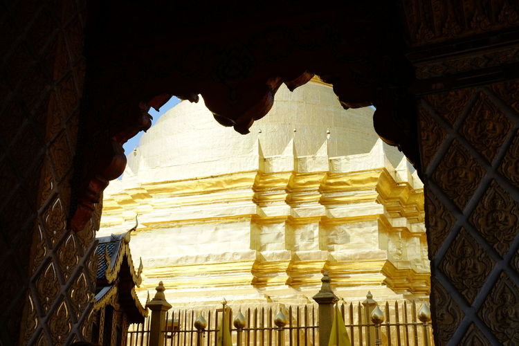 Low angle view of golden temple seen from archway