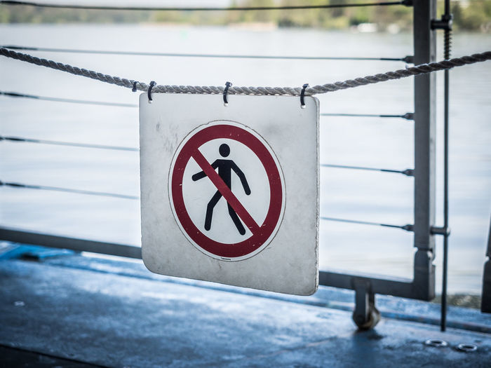 Close-up of do not enter sign on railing
