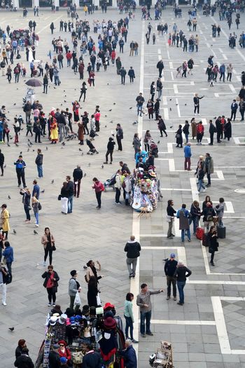 High angle view of people walking on square in city
