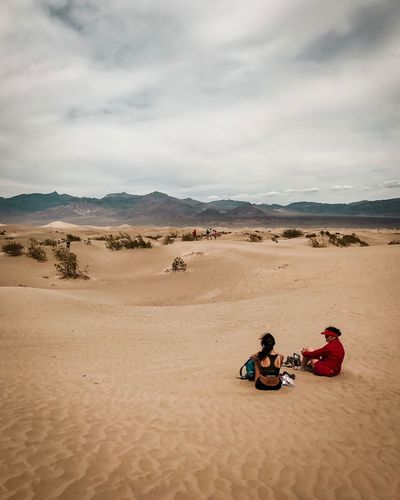Women sitting at desert
