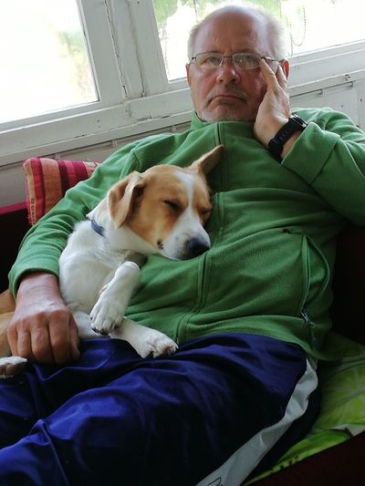 Man with dog sitting at home