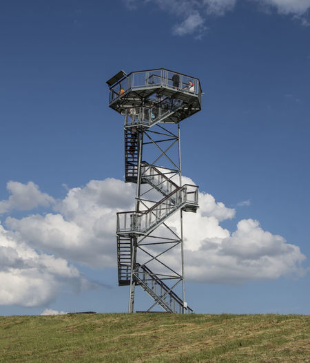 Lookout tower on field against sky