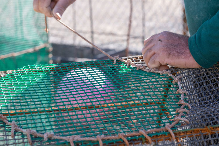 High angle view of man working with fishing net
